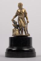 VULCAN: An early 20th Century brass Vulcan Cars Blacksmith mascot affixed to bakelite base, 11cm high