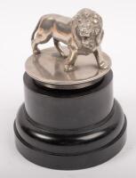 LION MASCOT: A pre-war car Lion mascot affixed to bakelite base, 7cm high (mascot only), 9cm long