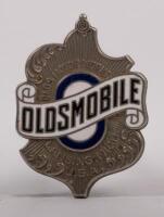 OLDSMOBILE: A fine detailed chrome enamel circa 1920s Oldsmobile radiator grille&nbsp;emblem badge, 5.5cm high, 4cm wide