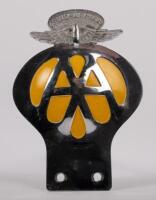 SOUTH AFRICA: A South African Automibile Association badge, with winged finial, Afrikans lettering to front, English to rear, yellow backplate, mounting holes, 14cm high, 9.5cm wide