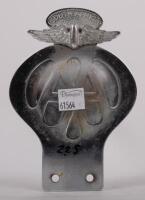 SOUTH AFRICA: A South African Automibile Association badge, with winged finial, Afrikans lettering to front, English to rear, yellow backplate, mounting holes, 14cm high, 9.5cm wide - 2
