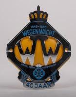 NETHERLANDS: A Dutch Tourist Association 40 year anniversary badge with crown finial, yellow backplate, mounting holes, 13.5cm high, 10.5cm wide