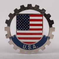 USA:&nbsp;MEXICO: A USA grille badge, cog design with painted centre, mounting pins, 8cm in diameter