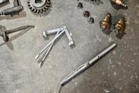 AUSTIN: A group of miscellaneous Austin Seven parts including&nbsp;idler gears, valves and steering link. [Location: Sydney] - 12
