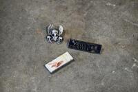 MISCELLANEOUS: Three miscellaneous items including Skull badge, lighter and Vauxhall badge. [Location: Sydney]