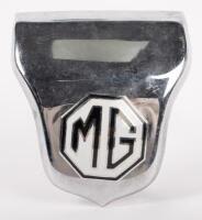 MG: A circa 1950s MG bonnet badge on chrome garnish, black lettering on white background, 5cm high, 5cm wide (badge only)