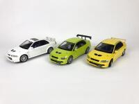 MITSUBISHI: Three 1:18 scale Mitsubishi Lancer Evolution cars produced by AutoArt (NB description)
