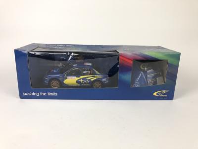 SUBARU: Unopened 1:18 scale Peter Solberg 2004 Rally Monte Carlo car and Subaru world rally team hat (NB description)