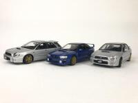 SUBARU: Three 1:18 scale Subaru Impreza's models produced by AutoArt (NB description)