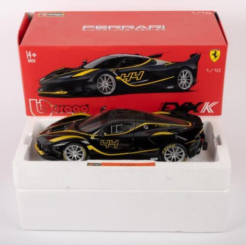 FERRARI FXX K: A 1:18 scale Ferrari FXX K, finished in black paintwork with yellow stripes, part of the signature series of models