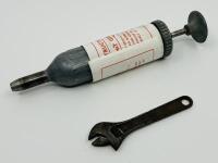 JAGUAR: An original grease gun and spanner, both tools from a 1950s/1960s era Jaguar tool kit [Location: Sydney]