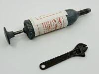 JAGUAR: An original grease gun and spanner, both tools from a 1950s/1960s era Jaguar tool kit [Location: Sydney] - 2