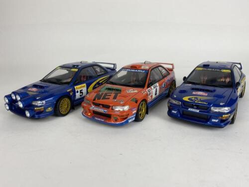 SUBARU: Three 1:18 scale Subaru Impreza racing cars produced by AutoArt (NB description)