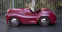A nice 1950s&nbsp;Austin J40 (Junior) pedal car, maroon paintwork appears to be original with touch-ups with later electric headlamps fitted, 45cm high, approx 1.4m long [Location: Melbourne]