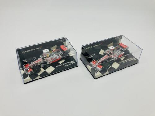MCLAREN-MERCEDES: Two Minichamps 1:43 scale models of the Vodafone McLaren Mercedes MP4-22 of Lewis Hamilton (2007) and MP4-23 Kovalainen boxed (2008) [Location: Sydney]