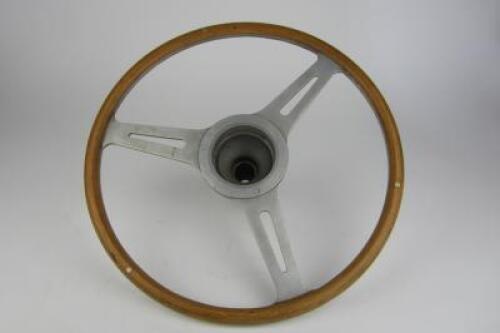 STEERING WHEEL: An aftermarket light weight wood grain steering wheel with boss