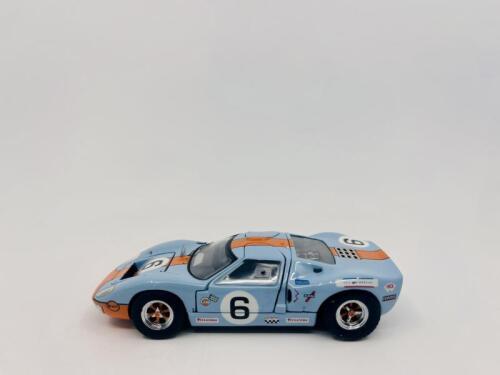 FORD: A 1:43 scale model by Jouef Evolution of the Ford GT40, winner of the 1969 Le Mans 24 Hours, driven by Jacky Ickx and Jackie Oliver, complete with original packaging [Location: Sydney]
