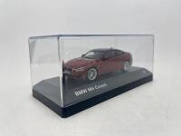 BMW: A 1:43 scale model by BMW of the BMW M4, complete with original packaging. [Location: Sydney] - 6