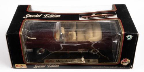 MERCEDES: A 1:18 scale 1966 Mercedes Benz 280SE convertible, burgundy colour, by Maisto Models, in damaged box