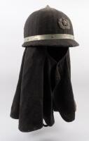 JAPAN WWII: A WWII era Japanese civil defense fire brigade helmet with skirt & badge to front