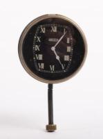 JAEGER: An early and rare Jaeger car clock, with white Roman numeral numbering on a black face, 8cm in diameter
