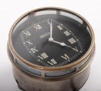 JAEGER: An early and rare Jaeger car clock, with white Roman numeral numbering on a black face, 8cm in diameter - 2