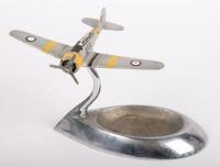 R.A.A.F. ASHTRAY: An RAAF ash tray, features a WWII era aircraft with RAAF roundels on stand attached to ash tray base, 11cm high, 19cm wide