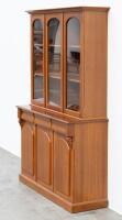 BOOK CASE: A two tiered timber bookcase by Pfitzner Furniture South Australia, featuring glazed display cabinetry, with a drawer and storage space to the lower, 137cm wide, 207cm high, 47cm deep - 13