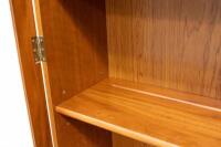 BOOK CASE: A two tiered timber bookcase by Pfitzner Furniture South Australia, featuring glazed display cabinetry, with a drawer and storage space to the lower, 137cm wide, 207cm high, 47cm deep - 16