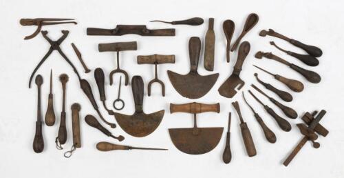 TOOLS: A collection of miscellaneous metal and timber hand tools likely for leather work
