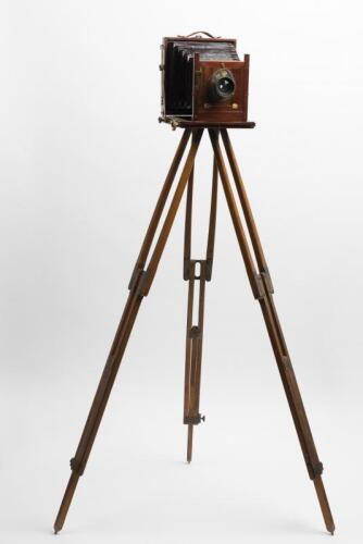 PHOTOGRAPHY: An early timber and brass tripod camera with tripod