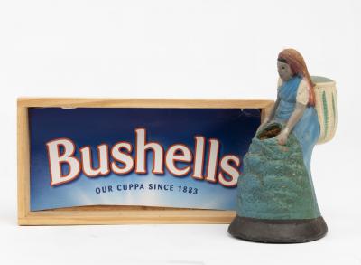 BUSHELLS: A rubber figurine of a woman collecting tea bushels