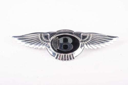 BENTLEY: A chrome winged Bentley bonnet badge, silver B over black enamel, two mounting pins, 4.5cm high, 16cm wide