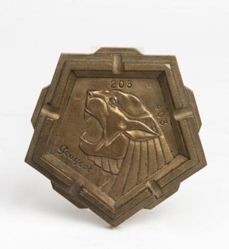 PEUGEOT: A late 1950s / early 1960s stylised pentagon shaped cast metal ashtray