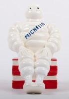 MICHELIN: A ceramic Michelin money box featuring&nbsp;Bibendum seated to a stack of books, approx 18cm high