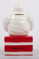 MICHELIN: A ceramic Michelin money box featuring&nbsp;Bibendum seated to a stack of books, approx 18cm high - 2