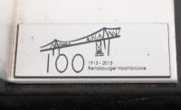 RENDSBURG HIGH BRIDGE: A bolt as removed&nbsp;from the Rendsburg&nbsp;High&nbsp;Bridge on a&nbsp;commemorative stand, engraved with '100 - 1913-2013 Rendsburger Hochbr&uuml;cke' - 2