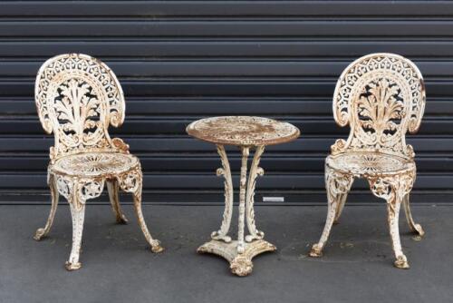 OUTDOOR: Three heavy cast-metal outdoor furniture set including two chairs and side table