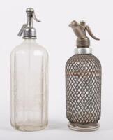 SODA SYPHONS: Two glass soda syphons, one etched 'Boon Spa Pty Ltd Melbourne', the other with netting, unmarked, largest 33cm high