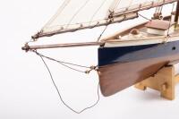 YACHT: A wooden model of an early sailing yacht with large fabric sails, approximately&nbsp;84cm in length, 83cm high, comes with a stand for base - 2