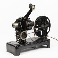 PROJECTOR: A c1920s Optica GMBH Heimkino 35mm hand operated projector, made in Bavaria Germany, complete with case and film titled 'In step with the times' - A Carl Dudley Production - New York - Beverly Hills' - 2