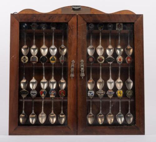 105 · COLLECTOR CAR SPOONS: A collection of vintage car logo motifs attached to spoons circa 1985, in display case