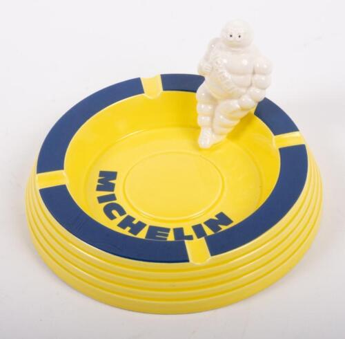 204 · MICHELIN ASHTRAY: A circa 1990s / 2000s ceramic Michelin ashtray, yellow with blue trim, seated Bibendum figure to side, 16cm in diameter