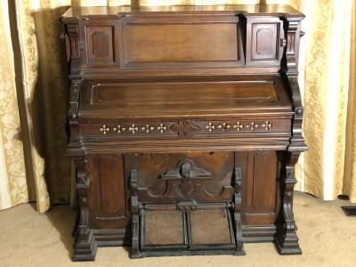 ORGAN: An American walnut reed organ by Peloubet & Co. New York (N.B location)