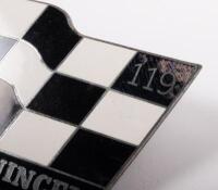 MAURIE QUINCEY: A chrome enamel Maurie Quincey 119 badge, chequered flag design, 6cm high, 10cm wide - 2