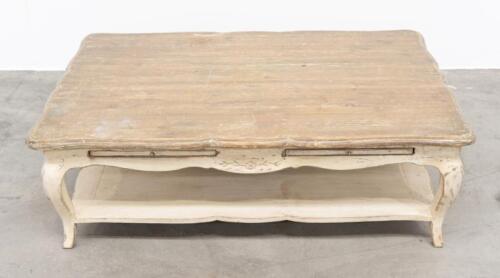22A · COFFEE TABLE: A rustic styled low coffee table, with cabriole style legs and carved detailing to the apron, measures 140cm wide, 91cm deep, 46cm high