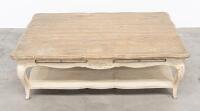 COFFEE TABLE: A rustic styled low coffee table, with cabriole style legs and carved detailing to the apron, measures 140cm wide, 91cm deep, 46cm high