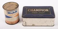 TINS: Two tins, including a Mobil one pound grease tin, along with a Champion Spark Plugs tin
