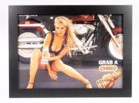 An original circa 2000s Chiko Roll advertising poster 'Grab a CHIKO' featuring Sarah Jane with a Harley Davidson motorcycle, framed and perspex glazed, 51cm high, 68cm wide overall