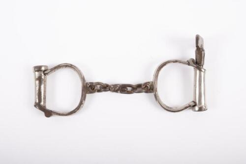 HANDCUFFS: A pair of original 19th century Hiatt Best Warranted Wrought handcuffs with key